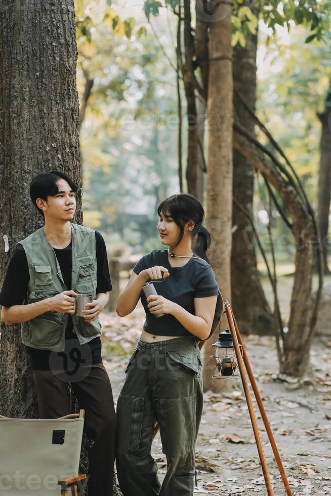 Asian couple sweet in tent inside on they camping trip, traveller relax and sleep togather in out door and camping trip photo