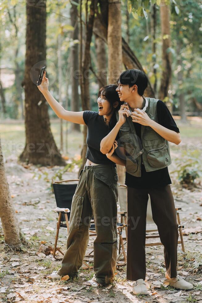 Asian couple sweet in tent inside on they camping trip, traveller relax and sleep togather in out door and camping trip photo
