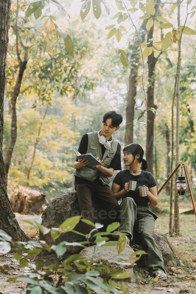 Asian couple sweet in tent inside on they camping trip, traveller relax and sleep togather in out door and camping trip photo