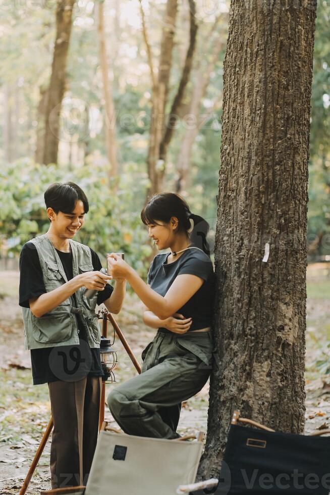 Asian couple sweet in tent inside on they camping trip, traveller relax and sleep togather in out door and camping trip photo