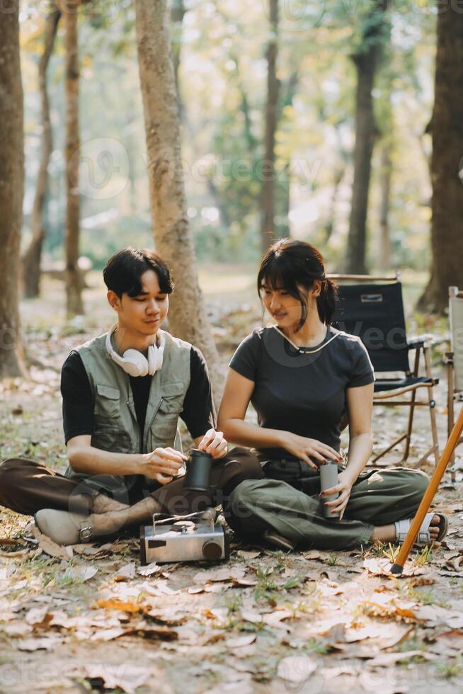 Asian couple sweet in tent inside on they camping trip, traveller relax and sleep togather in out door and camping trip photo
