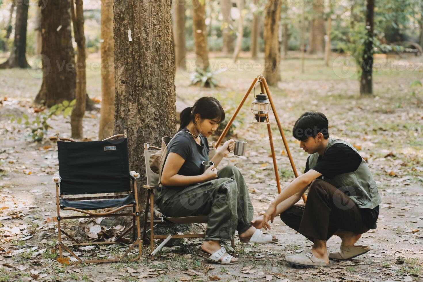 Asian couple sweet in tent inside on they camping trip, traveller relax and sleep togather in out door and camping trip photo