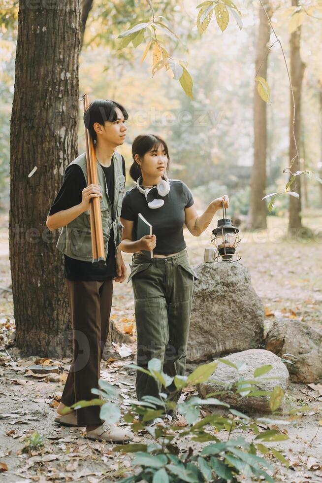 Asian couple sweet in tent inside on they camping trip, traveller relax and sleep togather in out door and camping trip photo