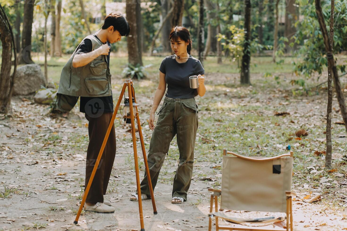 Asian couple sweet in tent inside on they camping trip, traveller relax and sleep togather in out door and camping trip photo