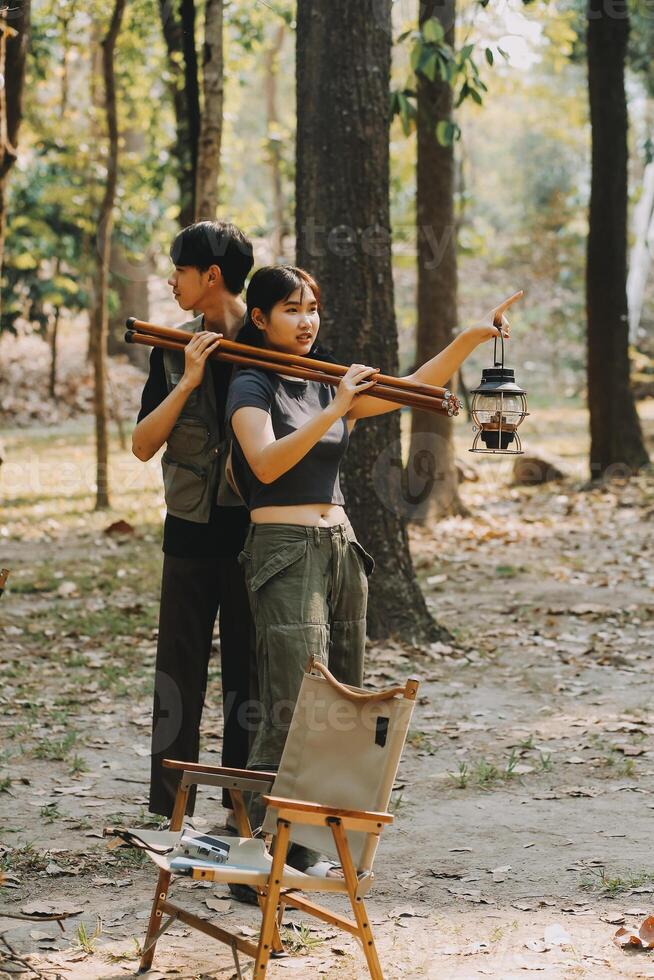 Asian couple sweet in tent inside on they camping trip, traveller relax and sleep togather in out door and camping trip photo