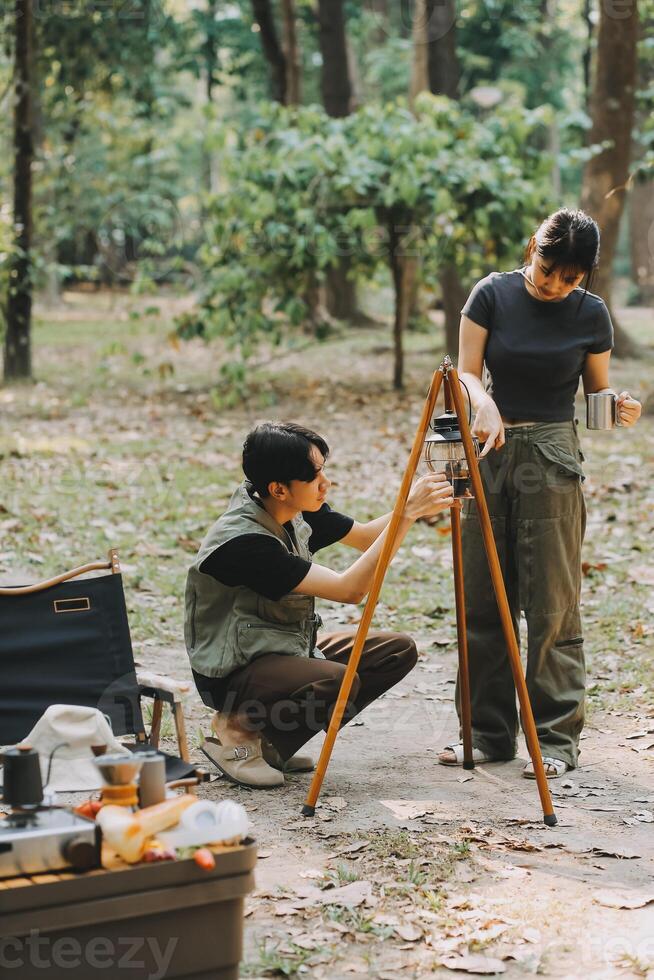 Asian couple sweet in tent inside on they camping trip, traveller relax and sleep togather in out door and camping trip photo