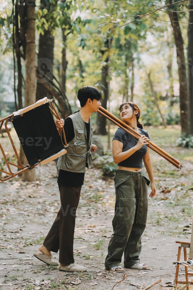 Asian couple sweet in tent inside on they camping trip, traveller relax and sleep togather in out door and camping trip photo