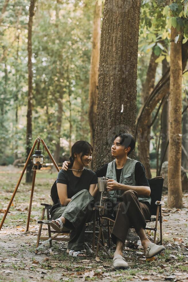 Asian couple sweet in tent inside on they camping trip, traveller relax and sleep togather in out door and camping trip photo