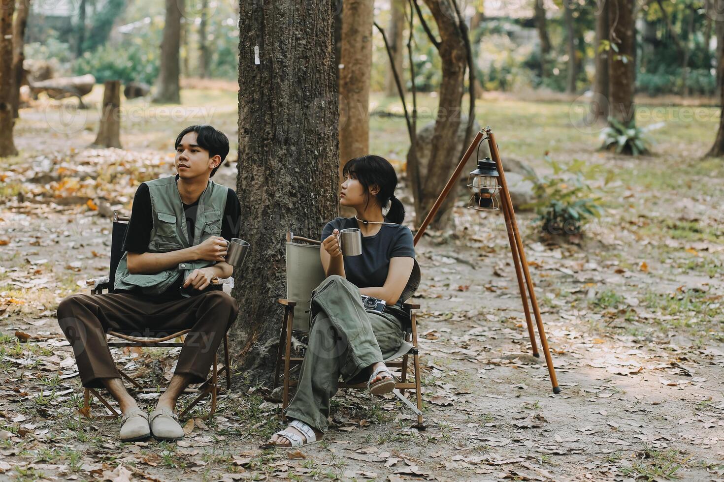 Asian couple sweet in tent inside on they camping trip, traveller relax and sleep togather in out door and camping trip photo