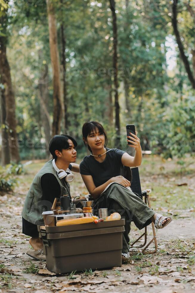 Asian couple sweet in tent inside on they camping trip, traveller relax and sleep togather in out door and camping trip photo