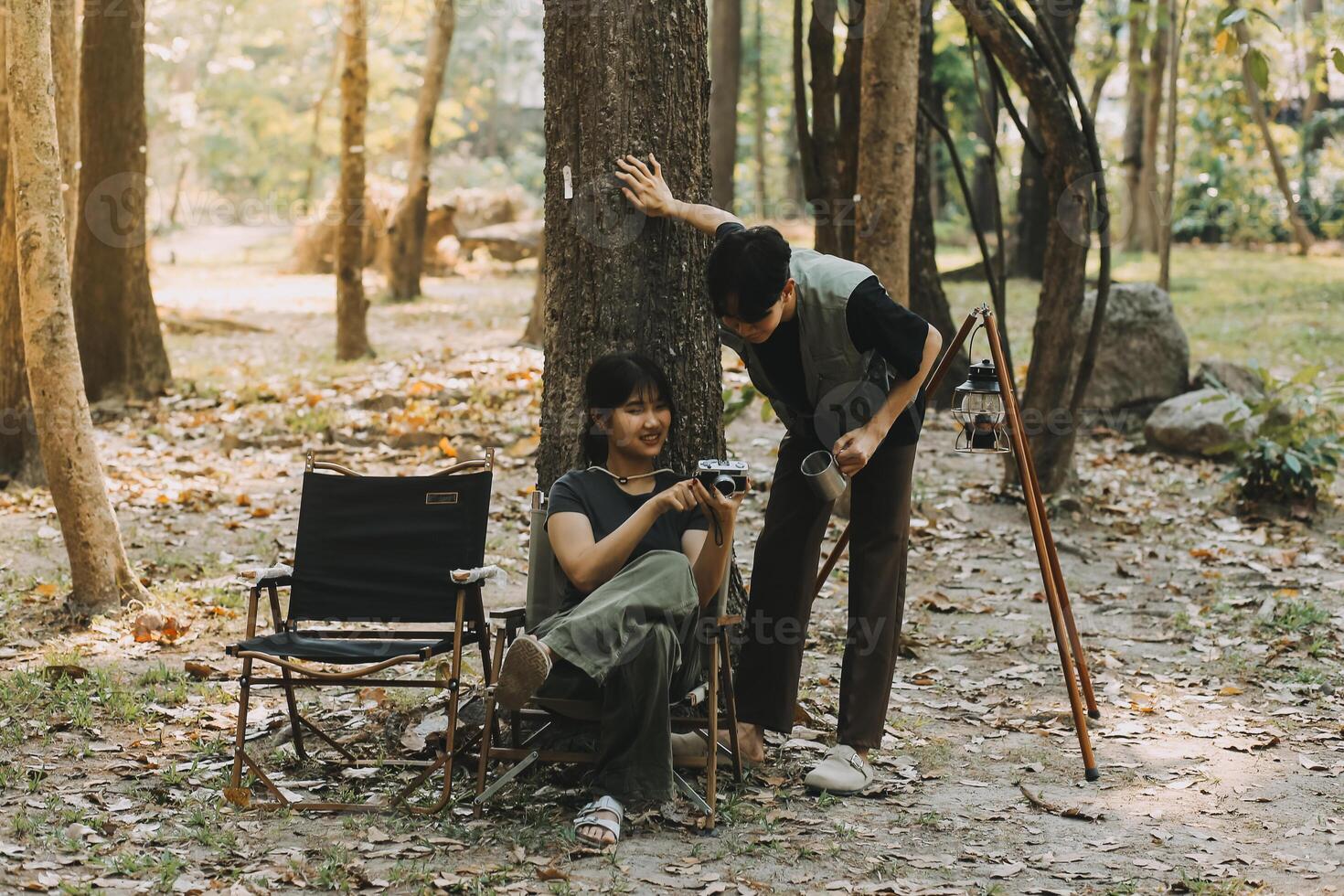 Asian couple sweet in tent inside on they camping trip, traveller relax and sleep togather in out door and camping trip photo