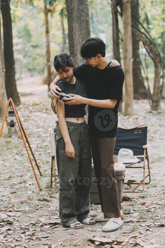 Asian couple sweet in tent inside on they camping trip, traveller relax and sleep togather in out door and camping trip photo