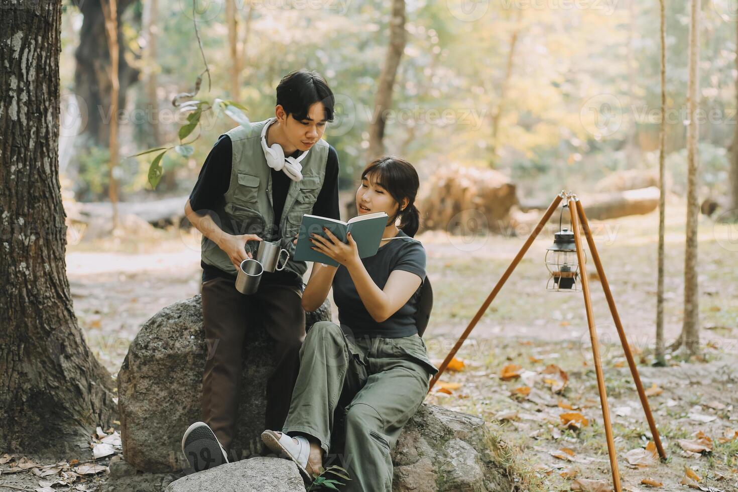 Asian couple sweet in tent inside on they camping trip, traveller relax and sleep togather in out door and camping trip photo