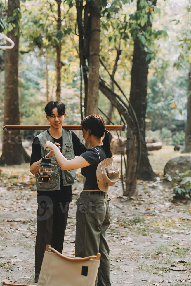 Asian couple sweet in tent inside on they camping trip, traveller relax and sleep togather in out door and camping trip photo