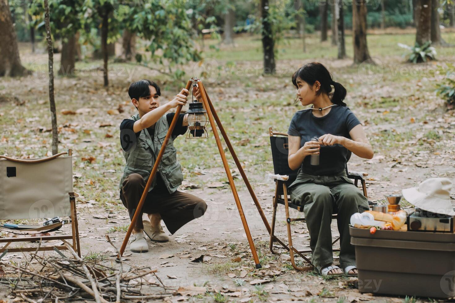 Asian couple sweet in tent inside on they camping trip, traveller relax and sleep togather in out door and camping trip photo