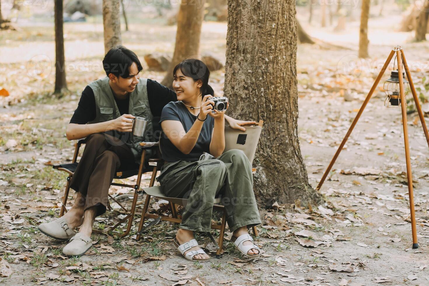 Asian couple sweet in tent inside on they camping trip, traveller relax and sleep togather in out door and camping trip photo