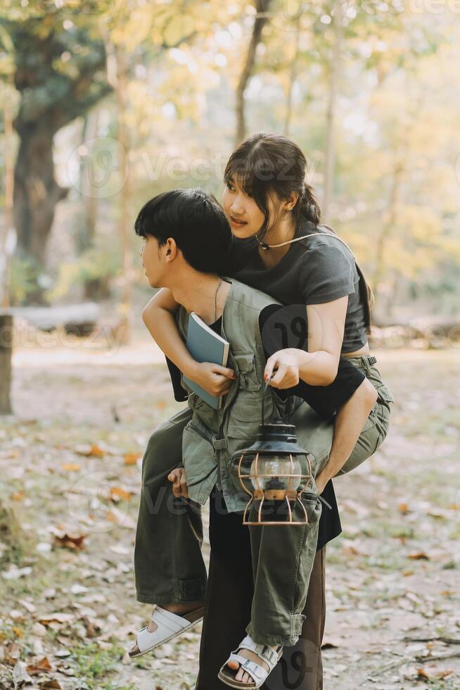 Asian couple sweet in tent inside on they camping trip, traveller relax and sleep togather in out door and camping trip photo