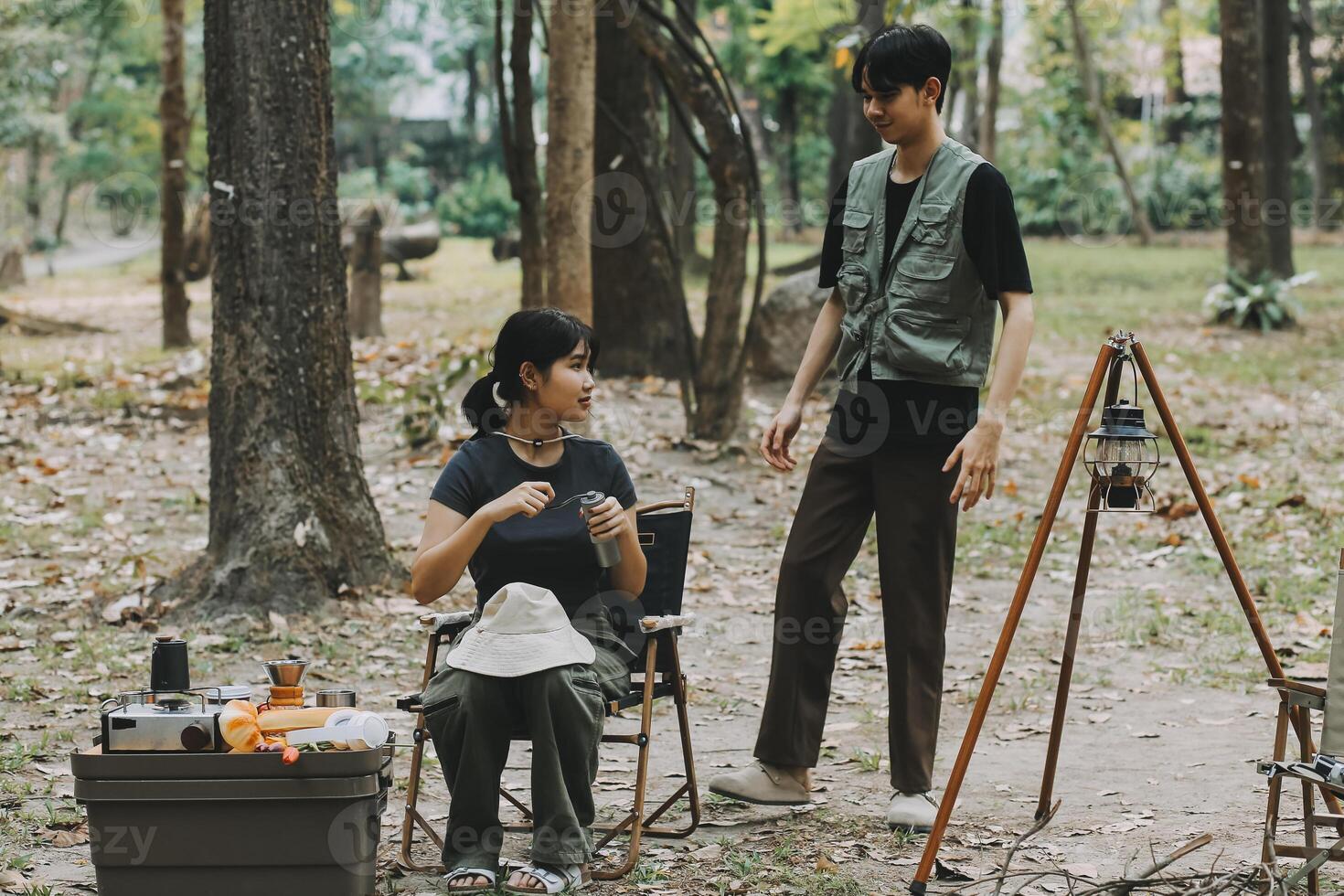 Asian couple sweet in tent inside on they camping trip, traveller relax and sleep togather in out door and camping trip photo