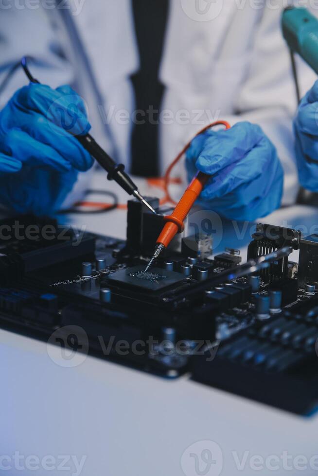 Close up of Technician measuring voltage electronic circuit board television, Service after sale fix electric equipment within insurance. photo