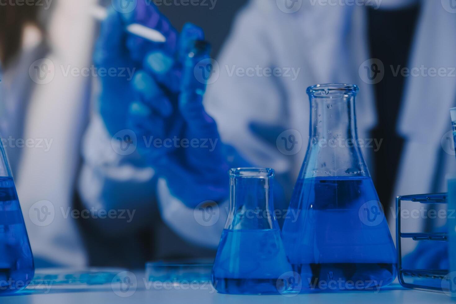 chemist,scientist hand dropping chemical liquid into test tube, science research and development concept photo