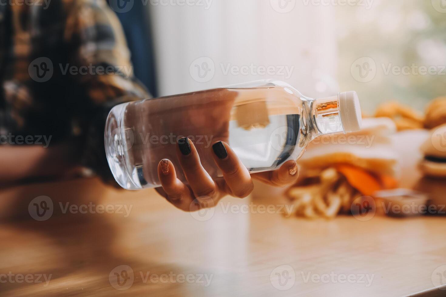 healthy beautiful young woman holding glass of water photo