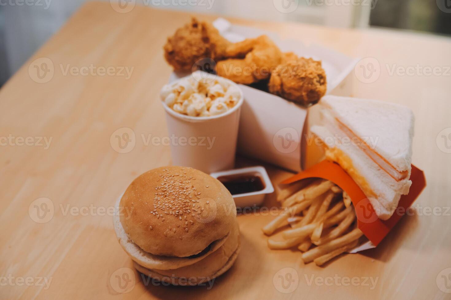 fast food, people and unhealthy eating concept - close up of woman hands holding hamburger or cheeseburger photo