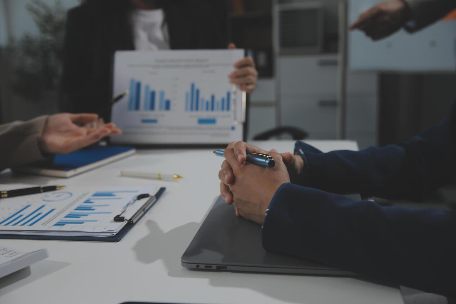 Business team collaboration discussing working analyzing with financial data and marketing growth report graph in team, presentation and brainstorming to strategy planning making profit of company. photo