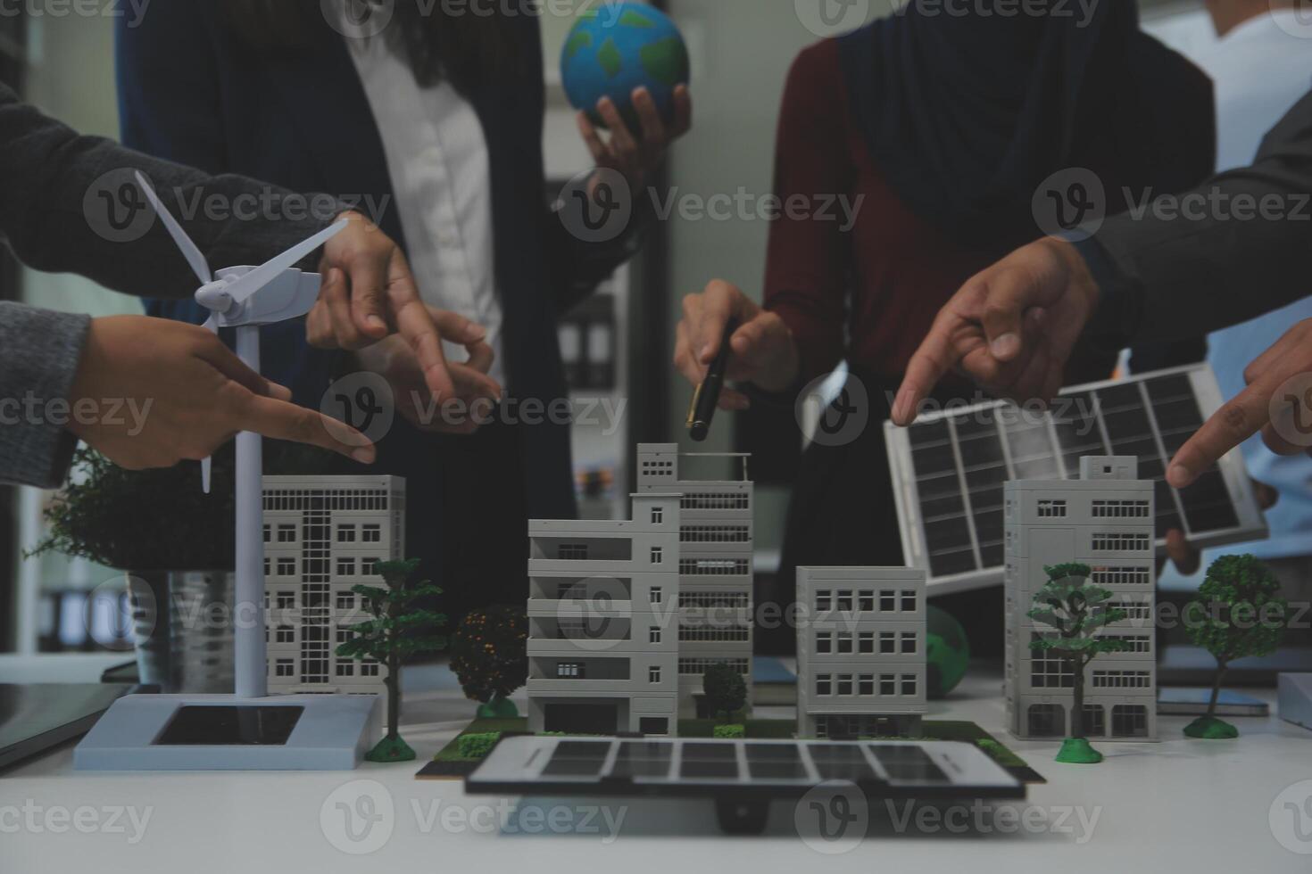 Business people having consultation about wind energy at company office. Business team discussing about windmill and alternative green energy. Executive meeting at modern office photo