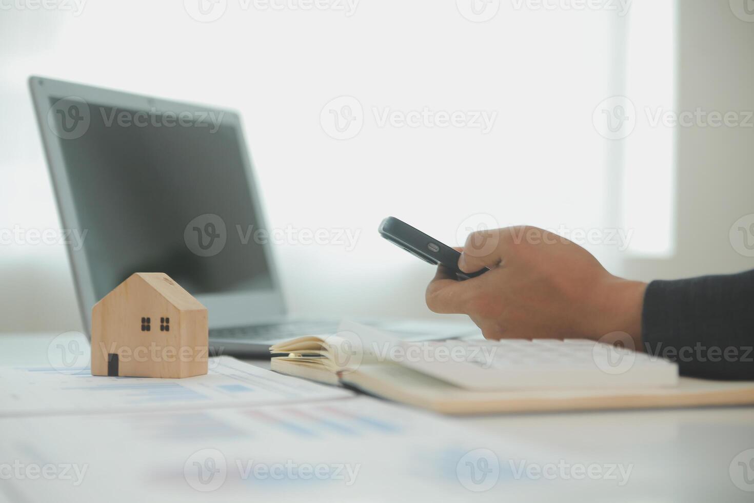 Businessmen holding pens, signing home titles with insurance, care about real estate services and the idea of real estate agents offering interest in installments to their customers. photo