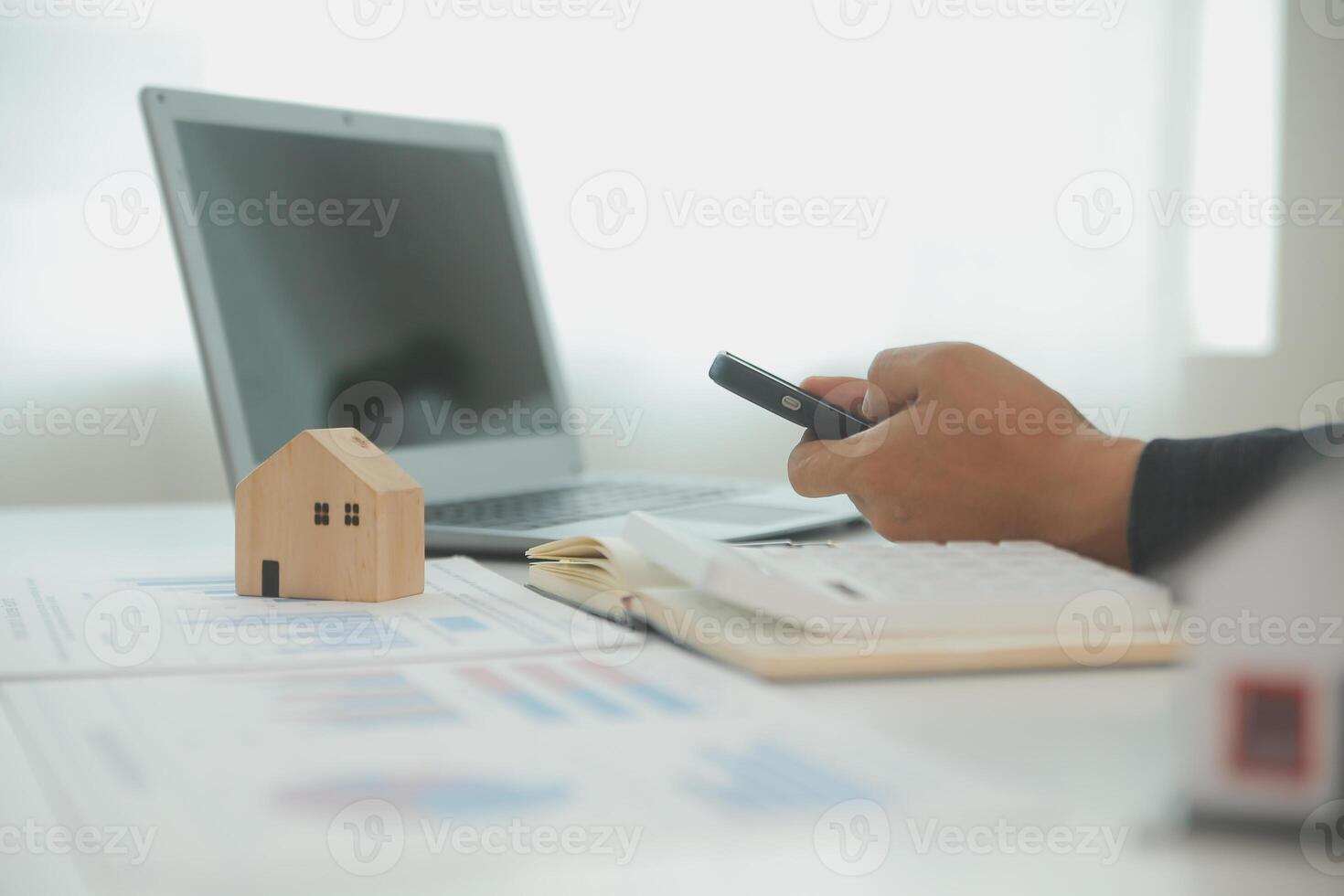 Businessmen holding pens, signing home titles with insurance, care about real estate services and the idea of real estate agents offering interest in installments to their customers. photo