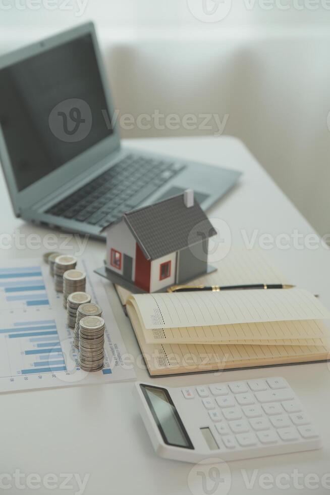 Saving money wealth concept, asian young business woman hand write management budget for saving cost, cash finance planning to spend enough money on her income for save money, payment tax, investing. photo