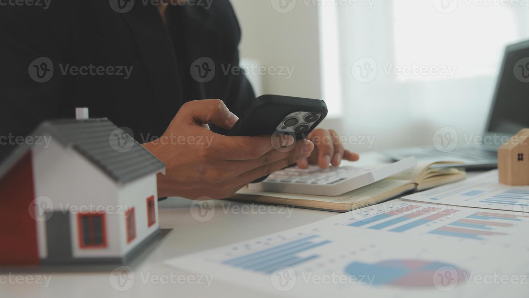 Businessmen holding pens, signing home titles with insurance, care about real estate services and the idea of real estate agents offering interest in installments to their customers. photo