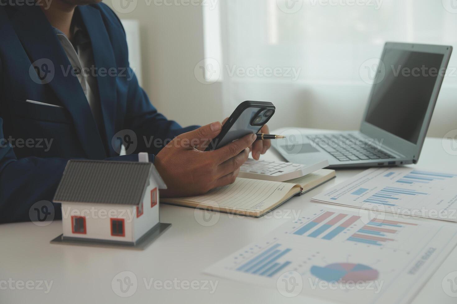 Businessmen holding pens, signing home titles with insurance, care about real estate services and the idea of real estate agents offering interest in installments to their customers. photo