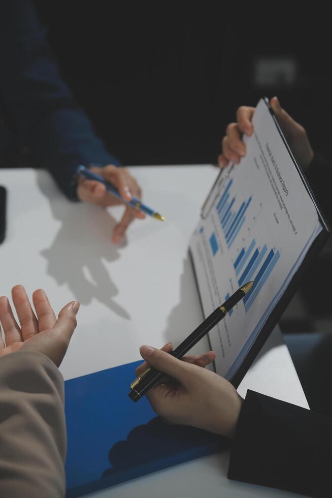 Business team collaboration discussing working analyzing with financial data and marketing growth report graph in team, presentation and brainstorming to strategy planning making profit of company. photo