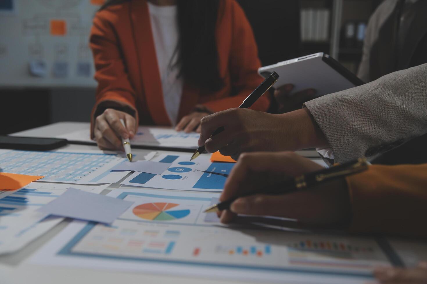 Business team collaboration discussing working analyzing with financial data and marketing growth report graph in team, presentation and brainstorming to strategy planning making profit of company. photo