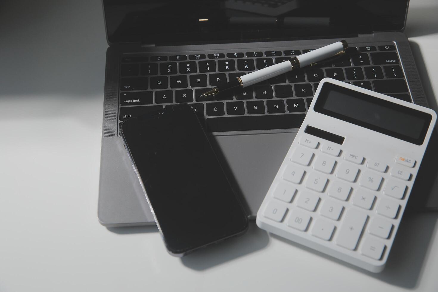 Office leather desk table with calculator and pen. Top view with copy space photo