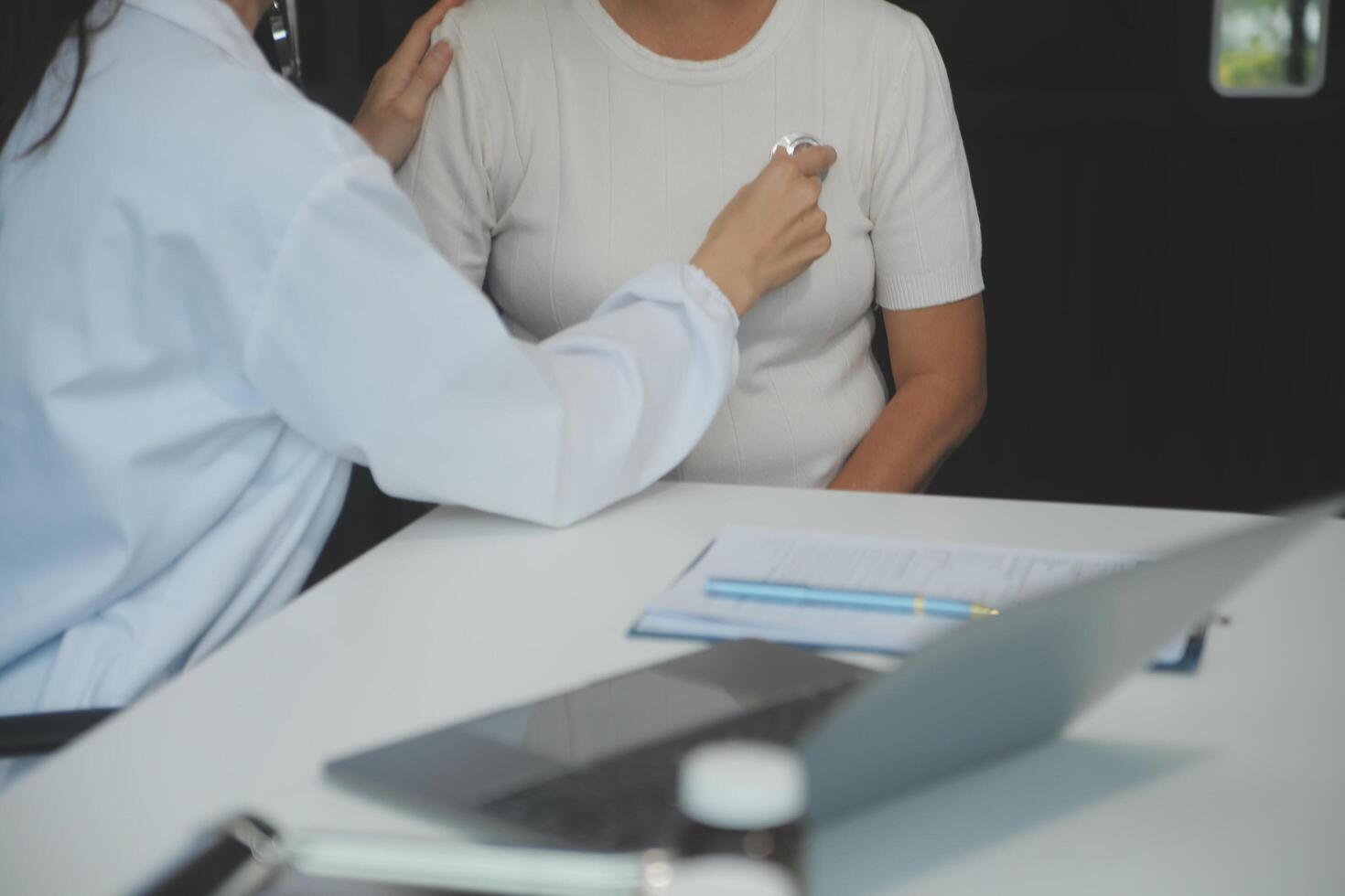 Doctor using sphygmomanometer with stethoscope checking blood pressure to a patient in the hospital. photo