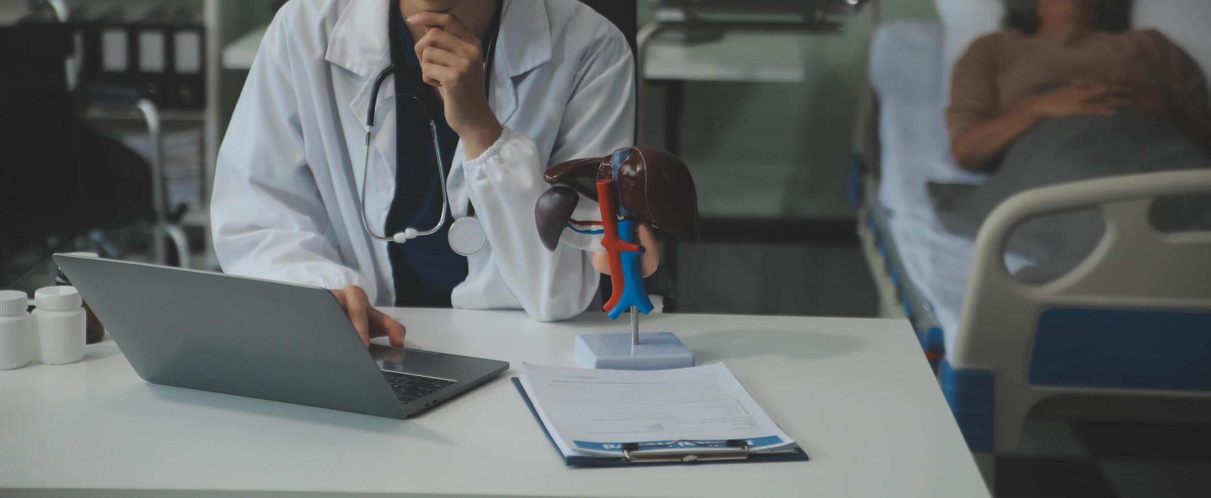 Female doctor explaining to patient results of model the process of patients. Diagnosis of diseases for Model Internal organ. photo