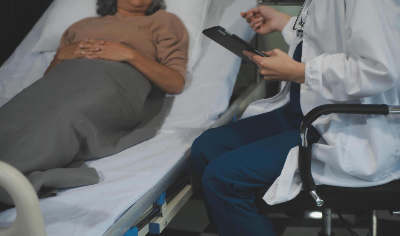 Cropped shot of a female nurse hold her senior patient's hand. Giving Support. Doctor helping old patient with Alzheimer's disease. Female carer holding hands of senior man photo