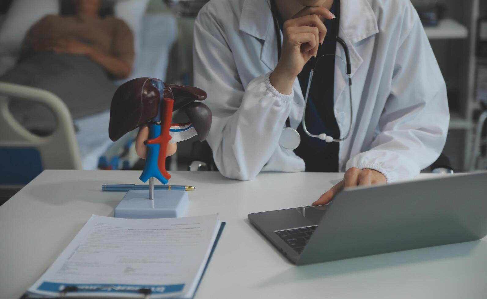 Female doctor explaining to patient results of model the process of patients. Diagnosis of diseases for Model Internal organ. photo