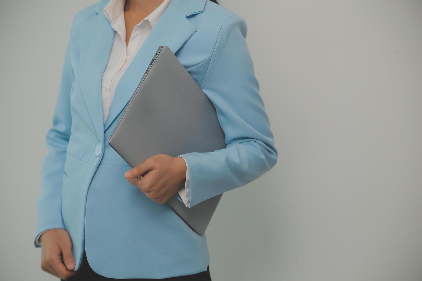 Portrait of a happy asian businesswoman working on laptop computer isolated over white background photo