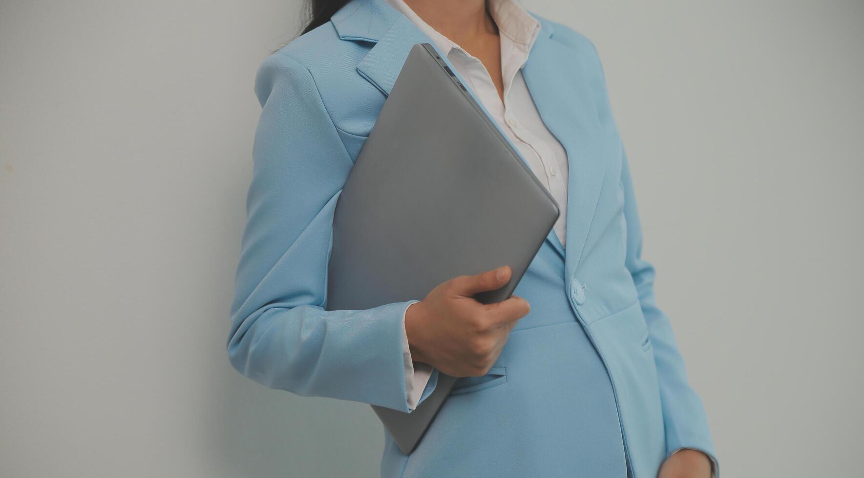 Portrait of a happy asian businesswoman working on laptop computer isolated over white background photo