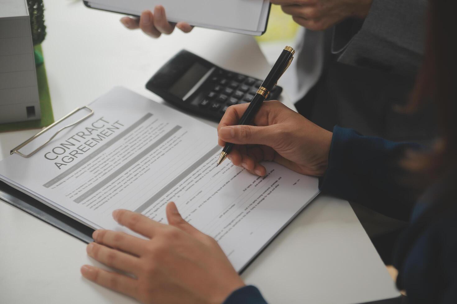 Business Signing a Contract Buy - sell house, insurance agent analyzing about home investment loan Real Estate concept. photo