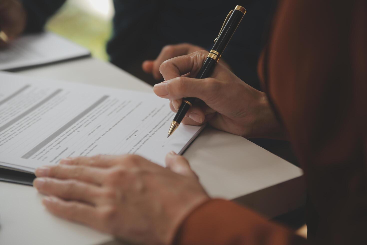 Lawyer, legal advisor, businessman brainstorming information on agreement details Business contracts in legal processing books for accuracy in contract documents. joint financial investment. photo