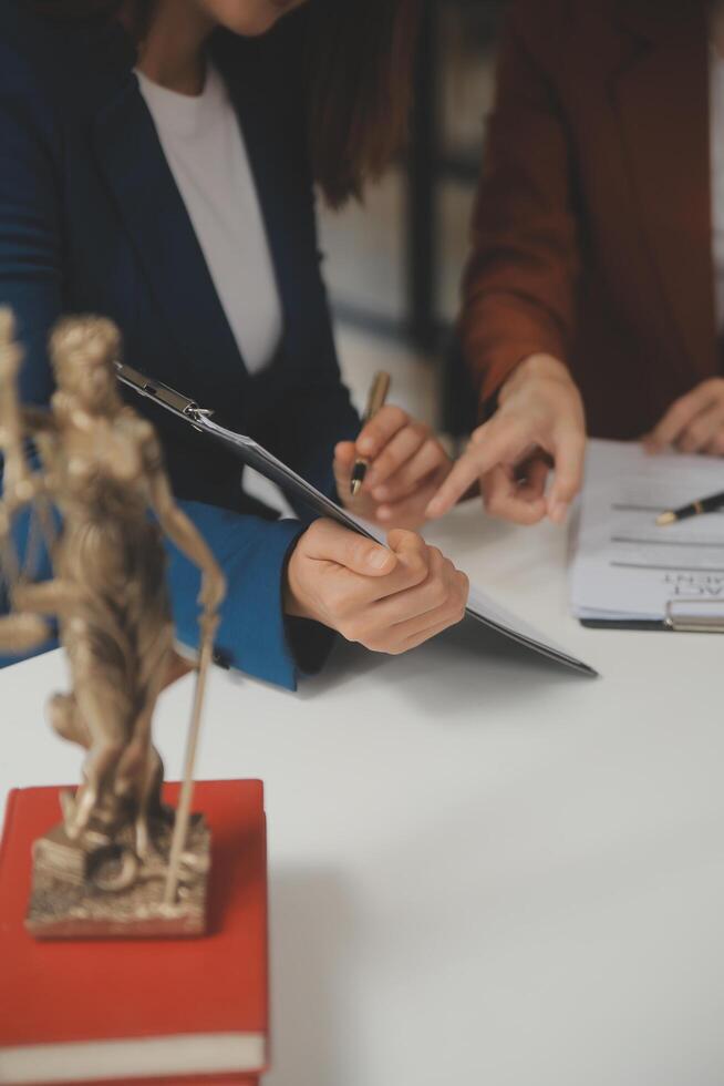 Lawyer, legal advisor, businessman brainstorming information on agreement details Business contracts in legal processing books for accuracy in contract documents. joint financial investment. photo