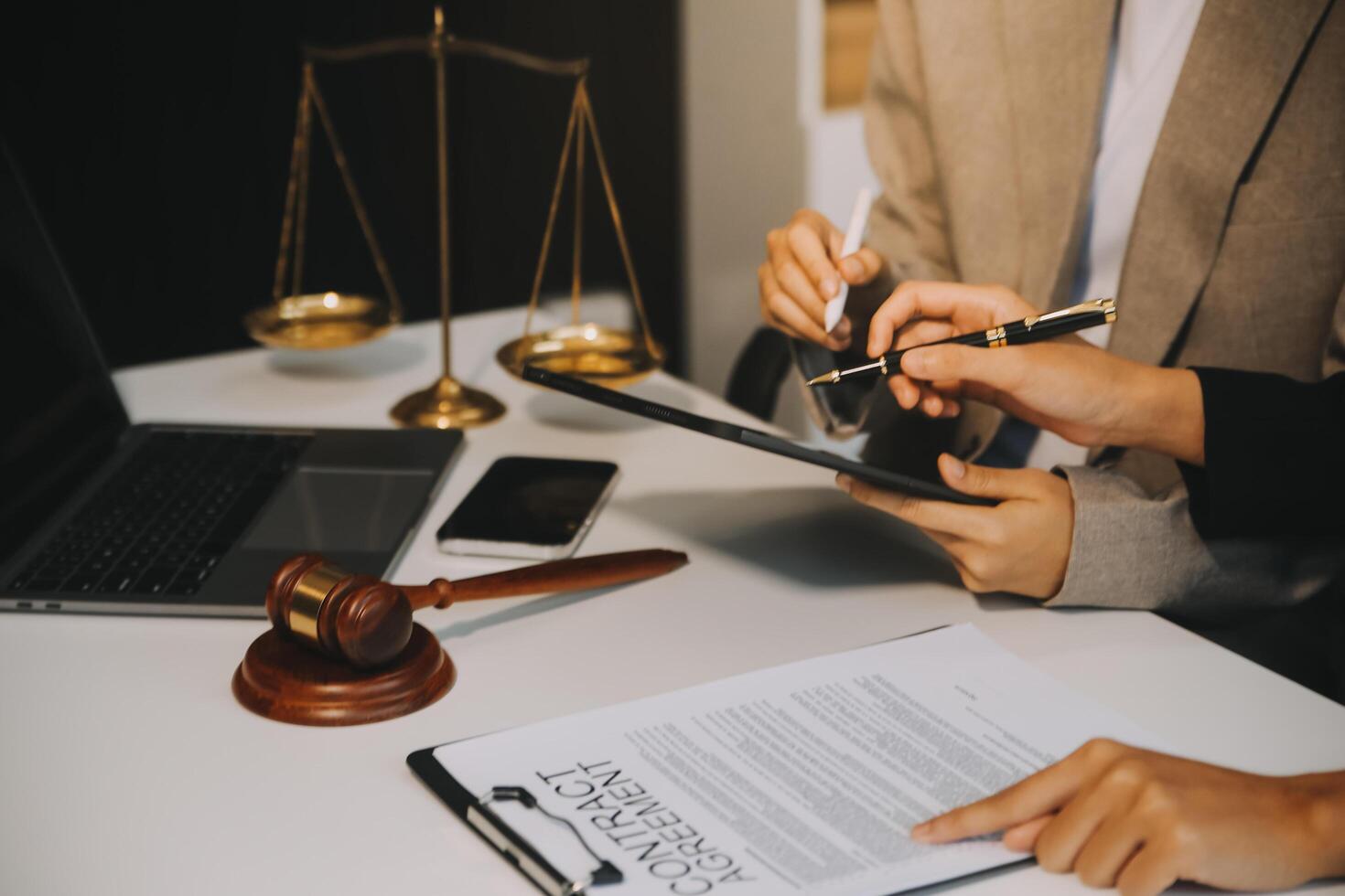 Lawyer, legal advisor, businessman brainstorming information on agreement details Business contracts in legal processing books for accuracy in contract documents. joint financial investment. photo