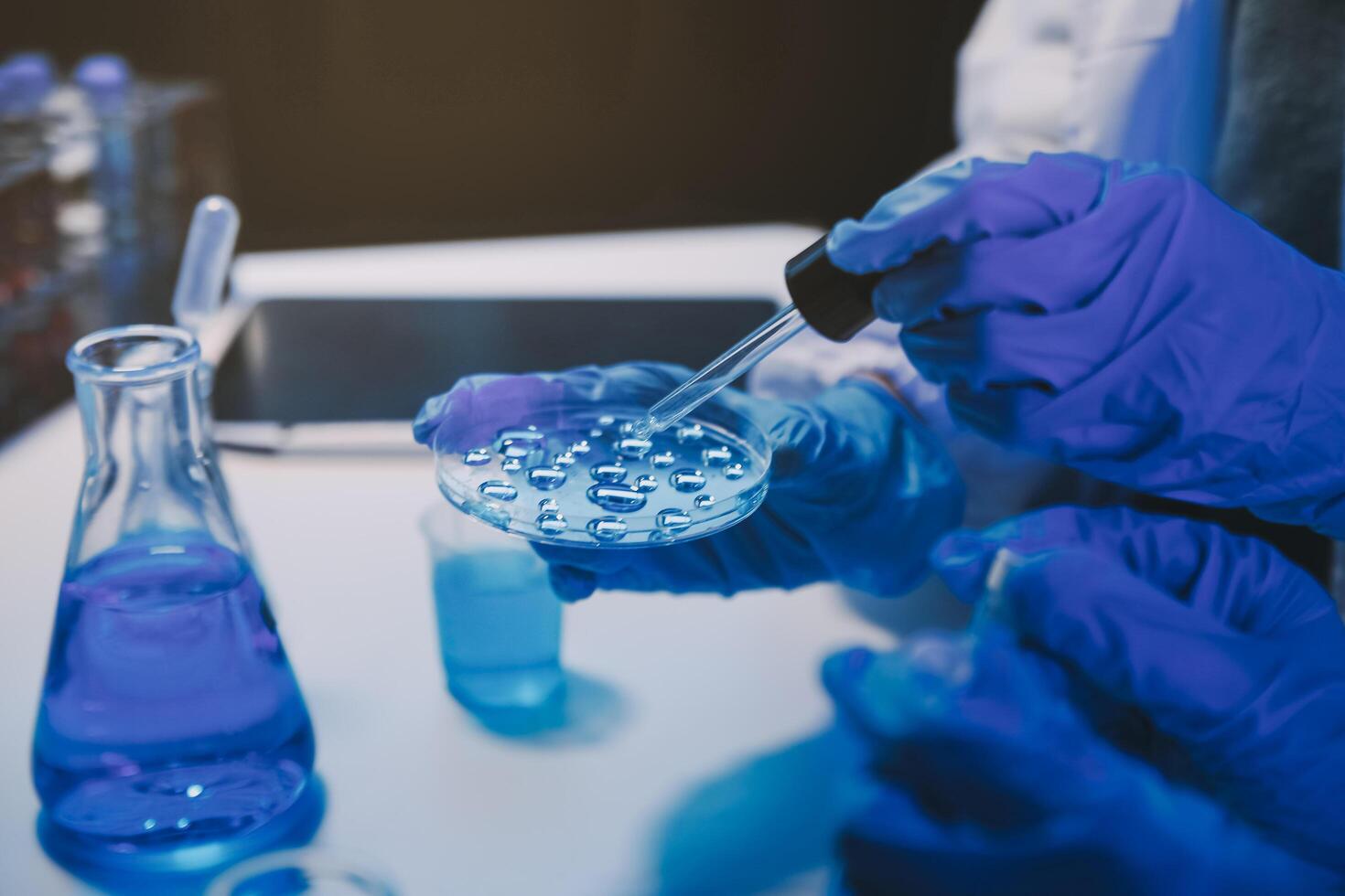 chemist,scientist hand dropping chemical liquid into test tube, science research and development concept photo