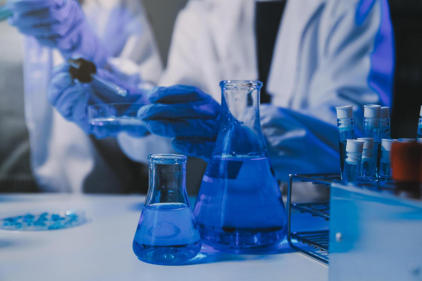 chemist,scientist hand dropping chemical liquid into test tube, science research and development concept photo