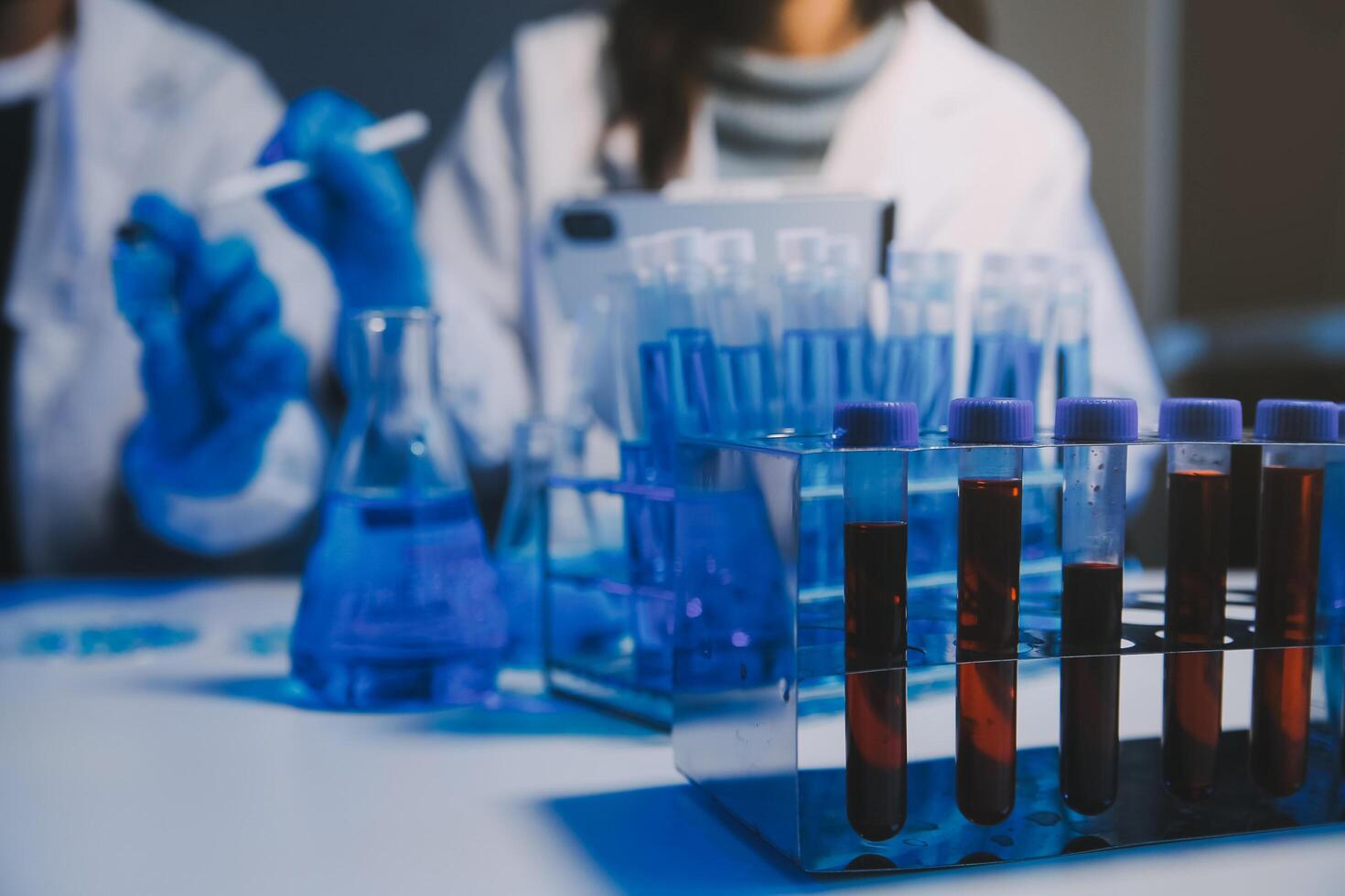 chemist,scientist hand dropping chemical liquid into test tube, science research and development concept photo