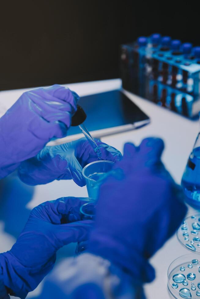 chemist,scientist hand dropping chemical liquid into test tube, science research and development concept photo